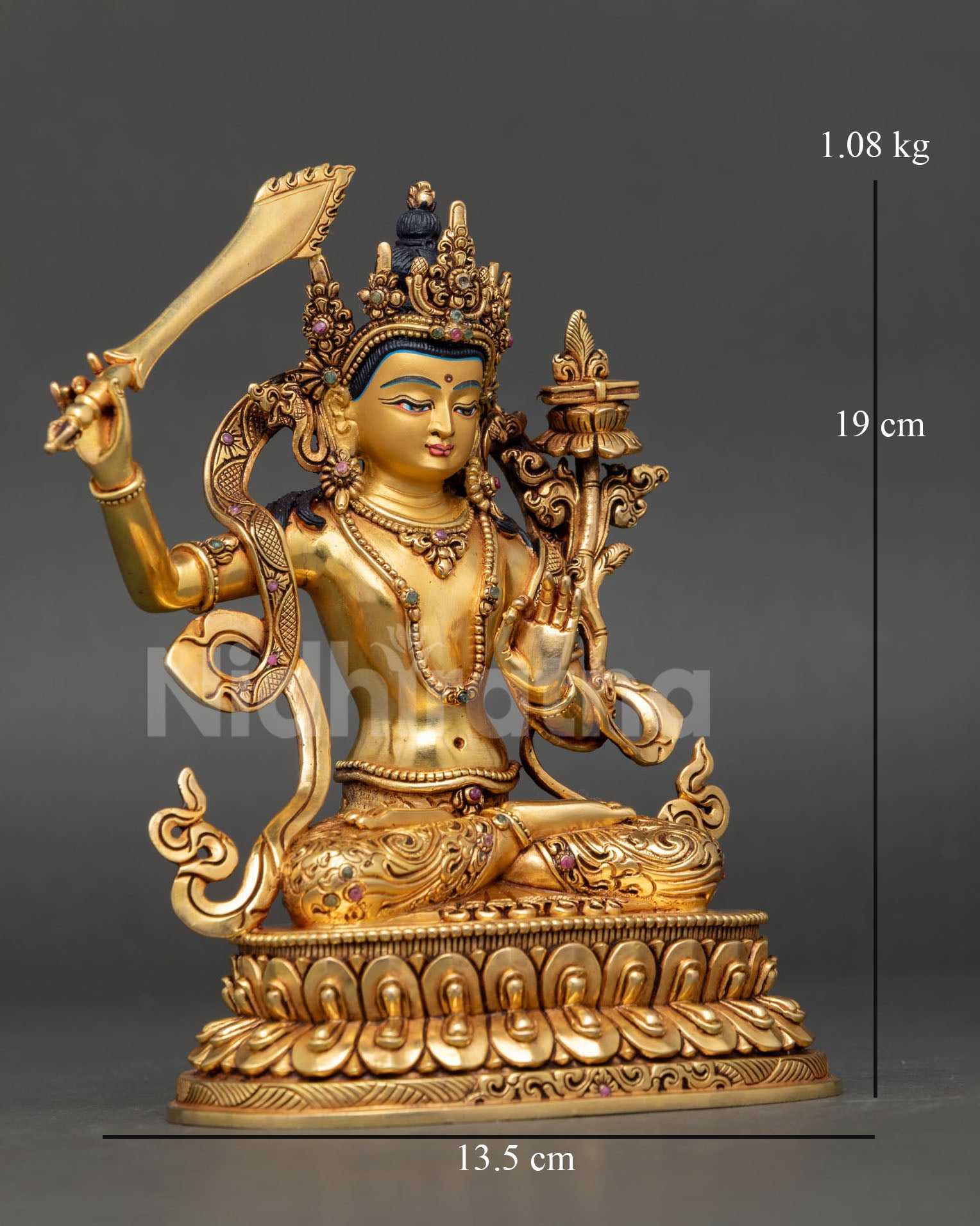 Right side view of Manjushri statue holding wisdom sword and flower