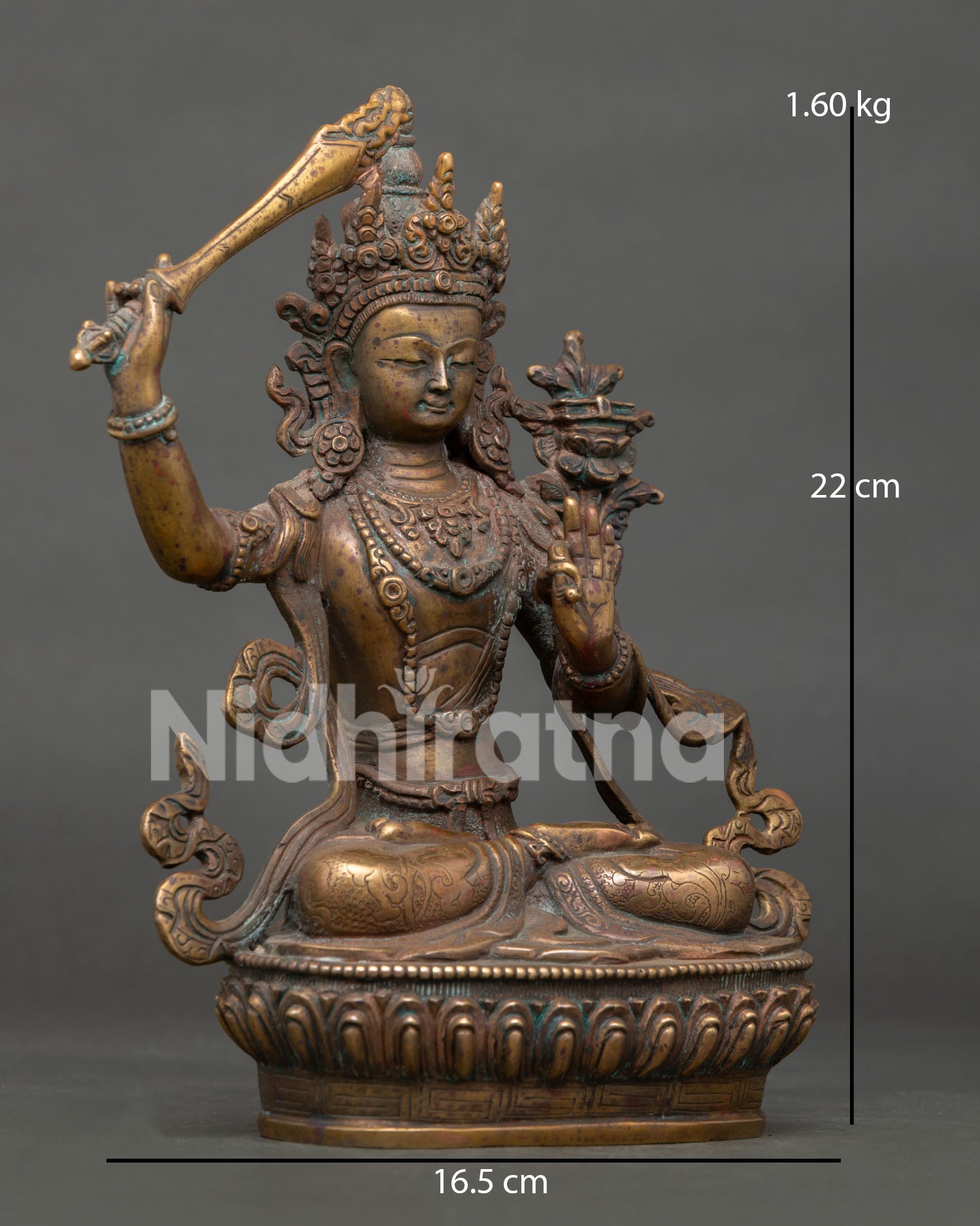 right side view of manjushri statue with lotus seat and antique copper patina