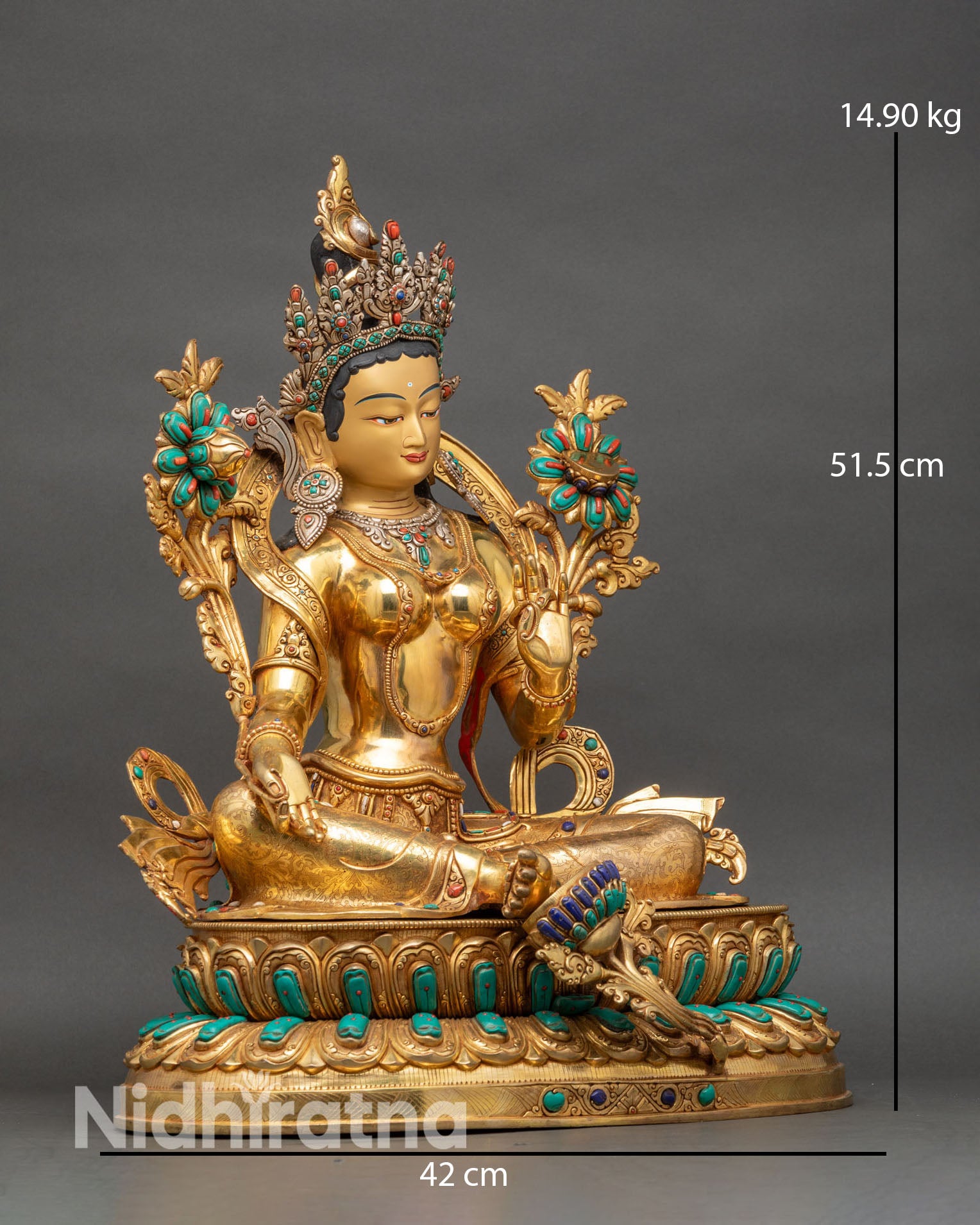 Right side view of monumental Green Tara statue seated in lalitasana on lotus throne