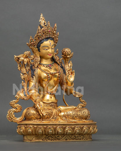 Right side view of Nepalese White Tara statue seated on a lotus base with gilded details