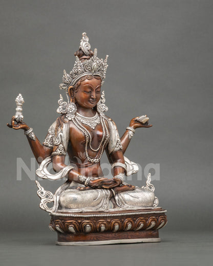 Right side view of Prajnaparamita statue holding a vajra, oxidized copper with silver plating