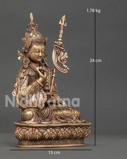 Right side view of pure copper Guru Tsokye Dorje statue with khatvanga staff