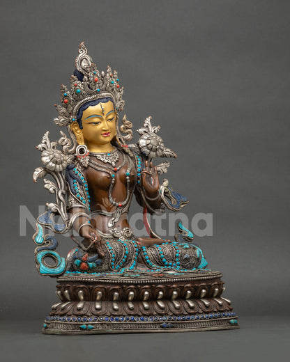 Right side view of Seven-Eyed White Tara statue, handcrafted copper figurine on lotus pedestal