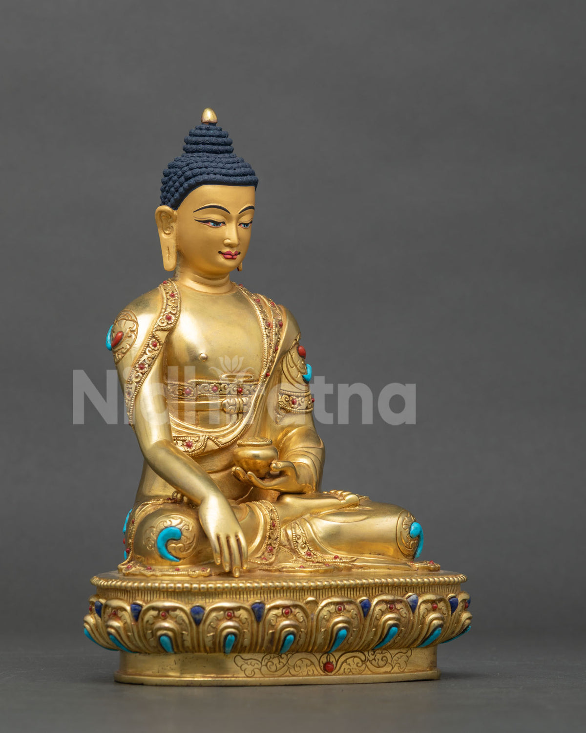 Right side view of the authentic copper Shakyamuni Buddha statue resting on a carved lotus base.