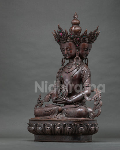 Right side view of the four-faced Vairocana Buddha statue with flowing scarves on a lotus base