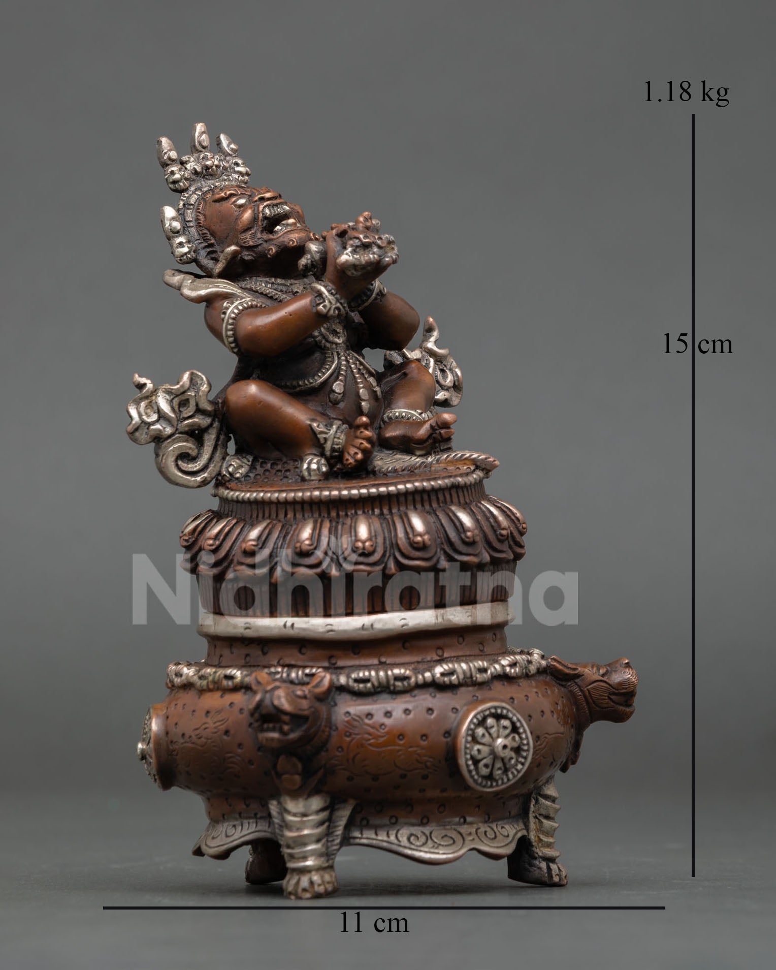 right side view of vajradaka buddhist statue with vajra and bell in hands