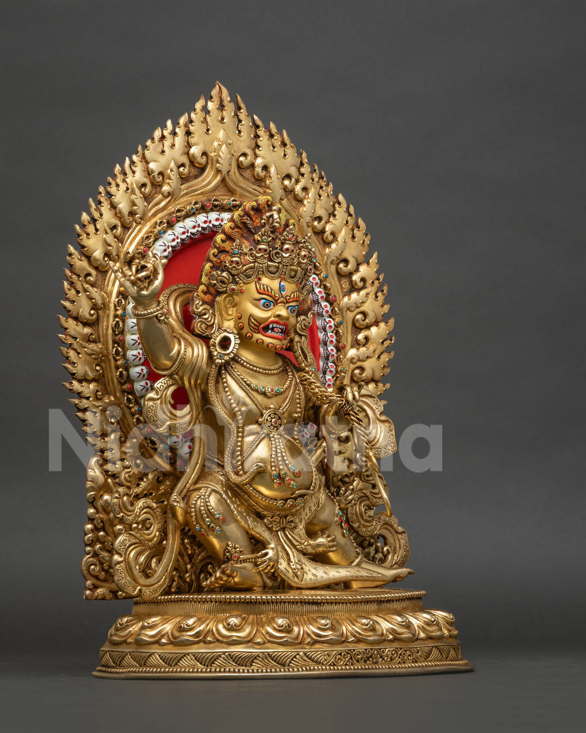 Right side view of Vajrapani statue with vajra, gold gilded copper and flaming halo