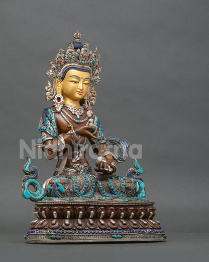 Right side view of Vajrasattva statue holding vajra on a double-layered lotus base, oxidized copper