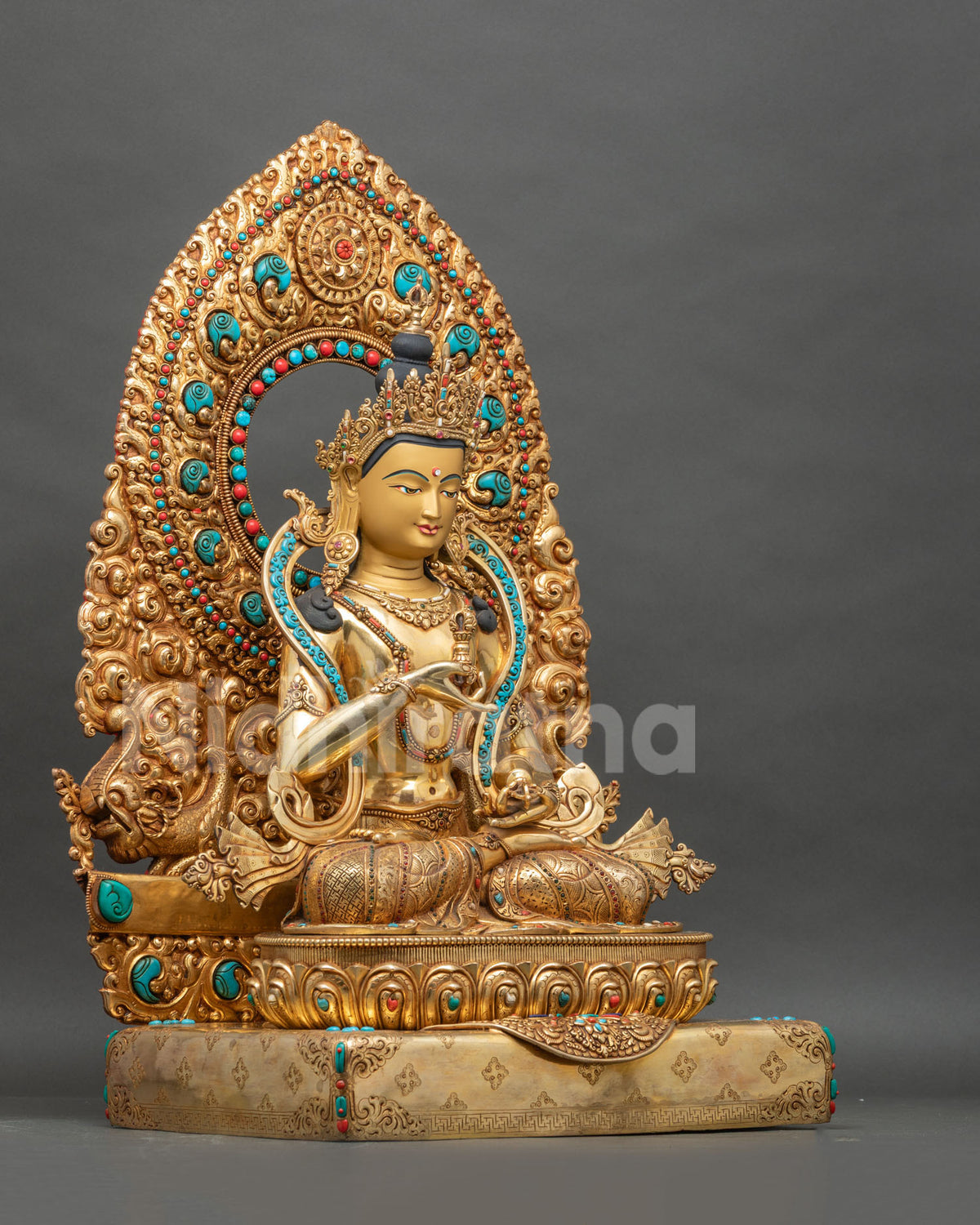 Right side view of Vajrasattva statue seated on lotus with ornate floral halo