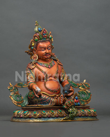 Right side view of Yellow Dzambhala copper statue holding a citron with engraved lotus base