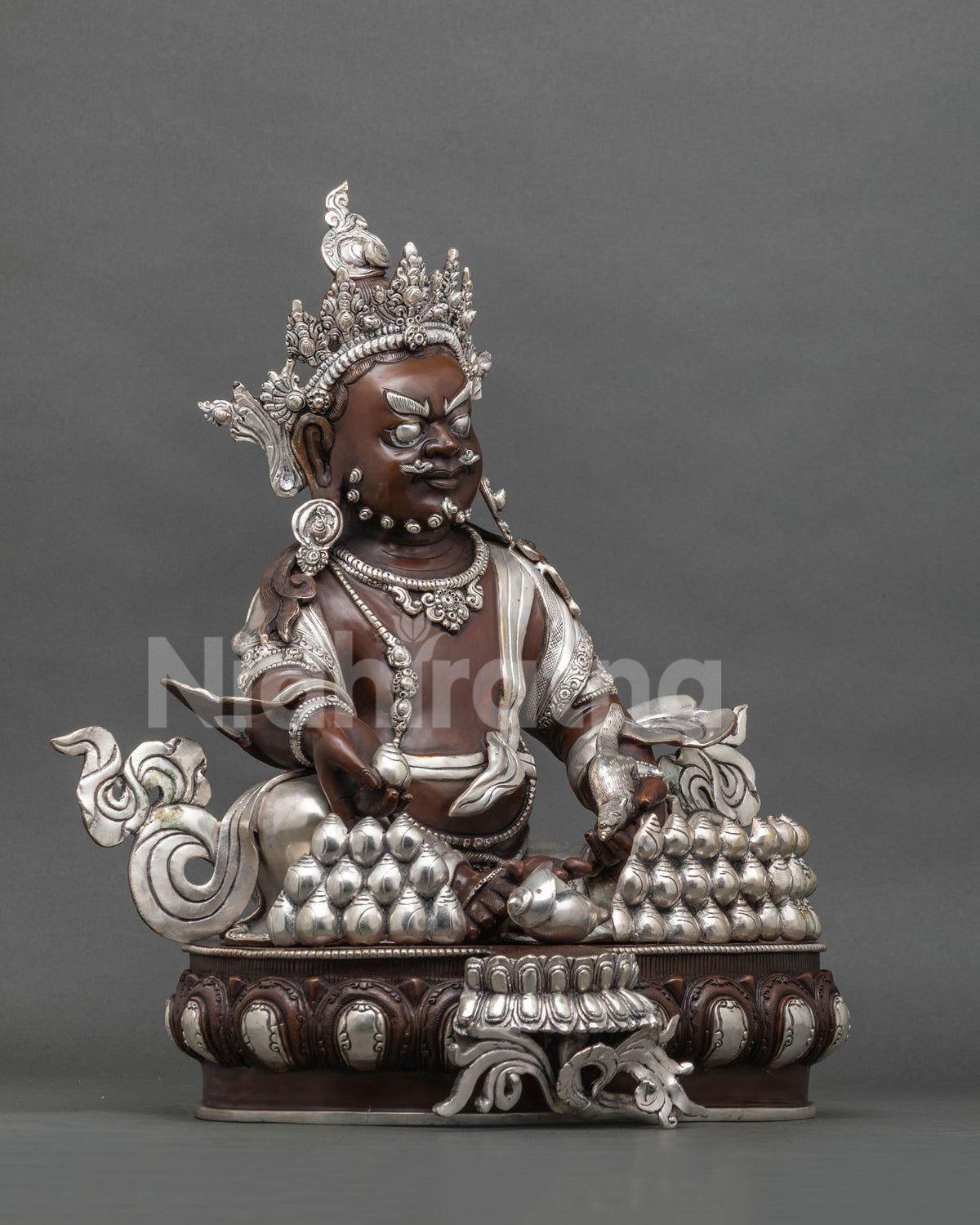 Right side view of Yellow Jambhala statue with conch and silver plated lotus base