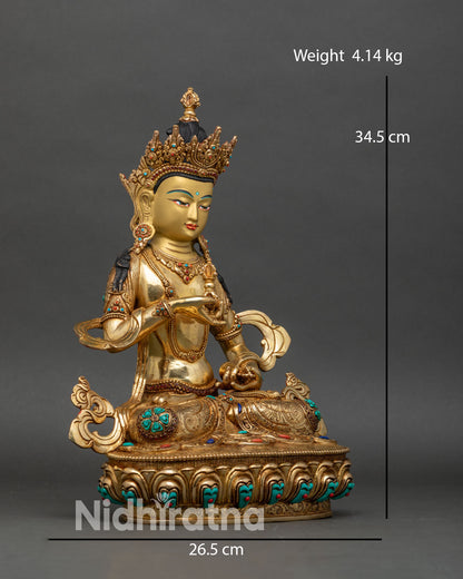 Right side view of Vajrasattva statue holding vajra and bell, gilded copper