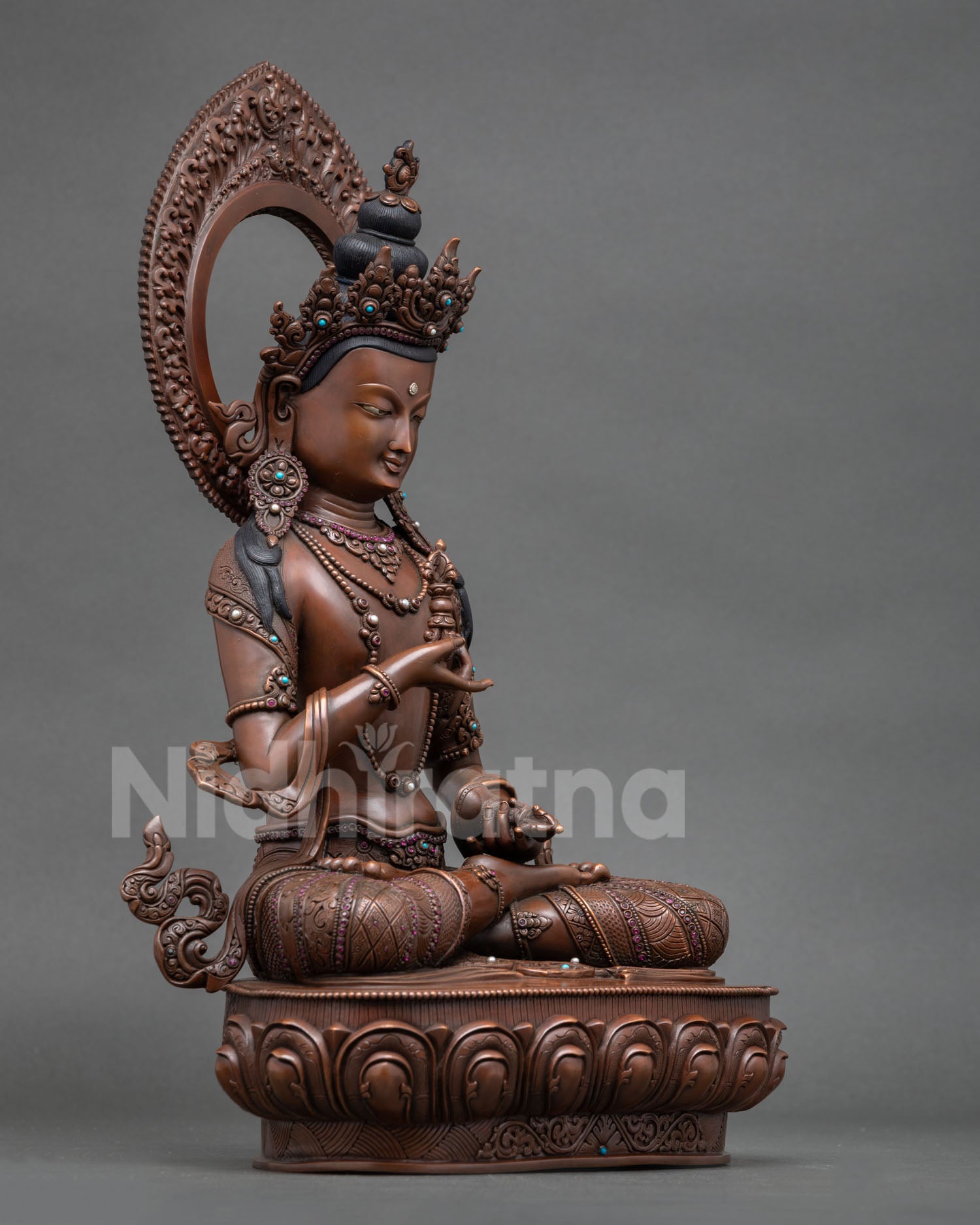 Right view of Dorje Sempa statue holding vajra and bell on lotus throne