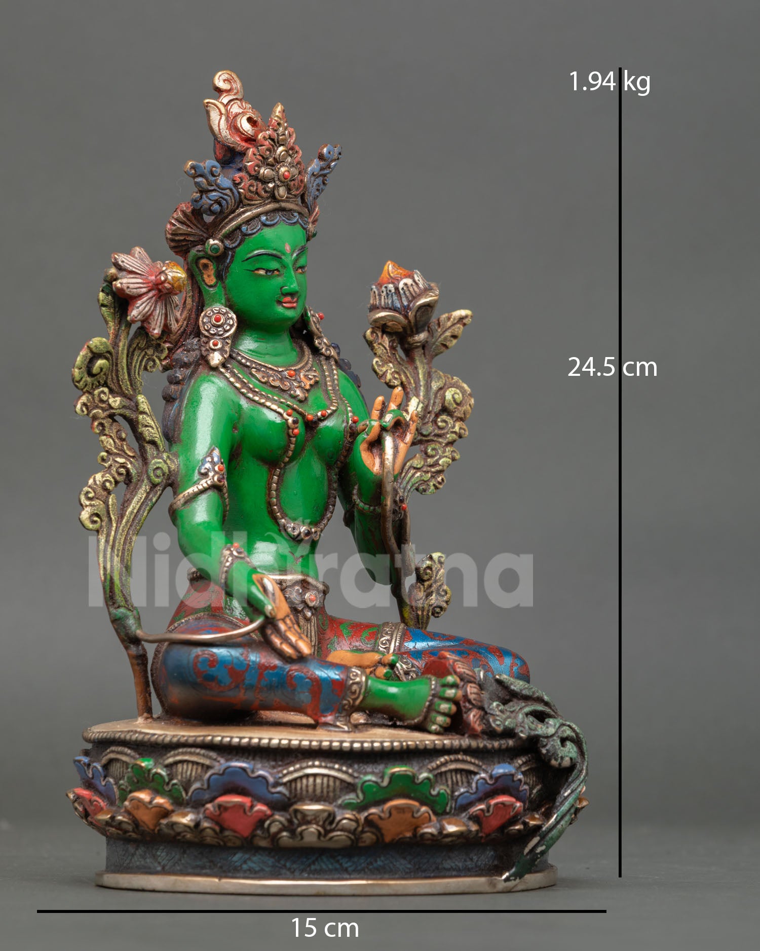 right view of green tara statue with utpala flower and semi-precious stone decor