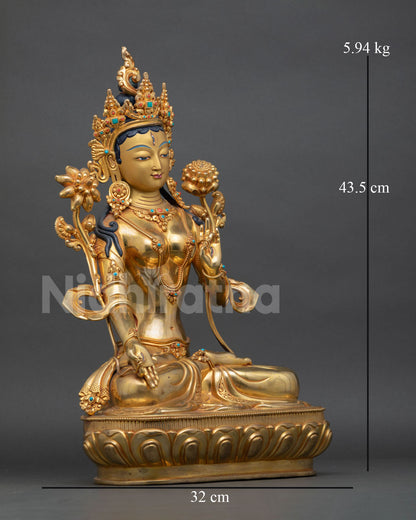 right view of white tara meditation statue with utpala flower and lotus base