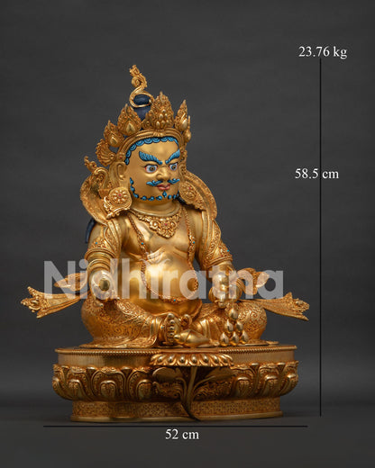 Right view side of Dzambhala statue showing gold gilded robe patterns and mongoose symbolism