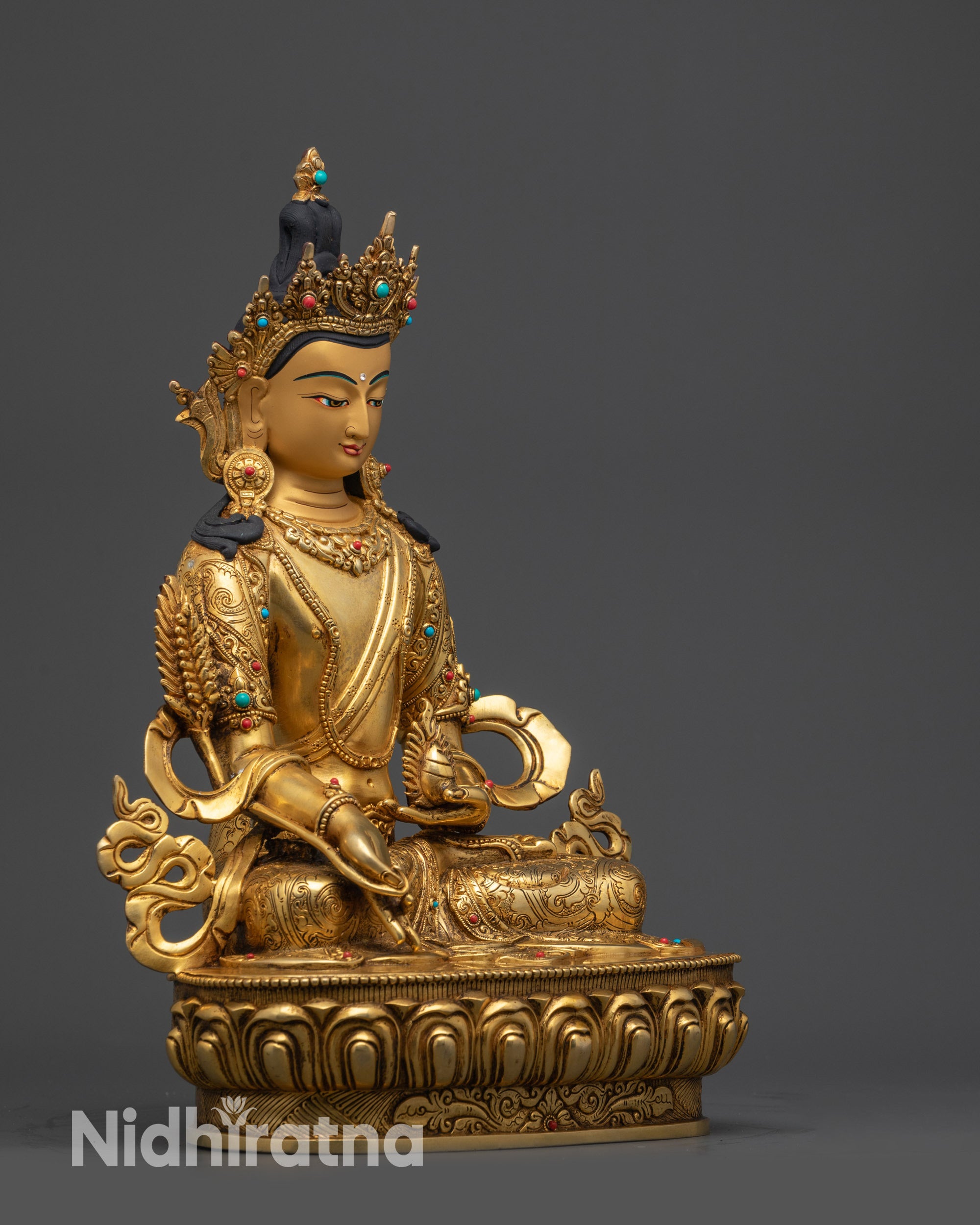 right view side kshitigarbha statue with ornate robe and semi-precious stones
