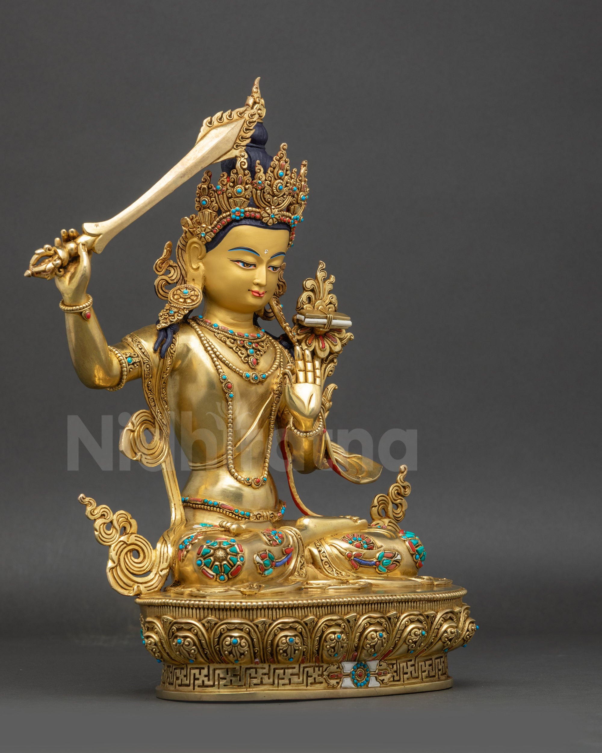 right view side of Manjushri statue showing flowing robes and lotus pedestal
