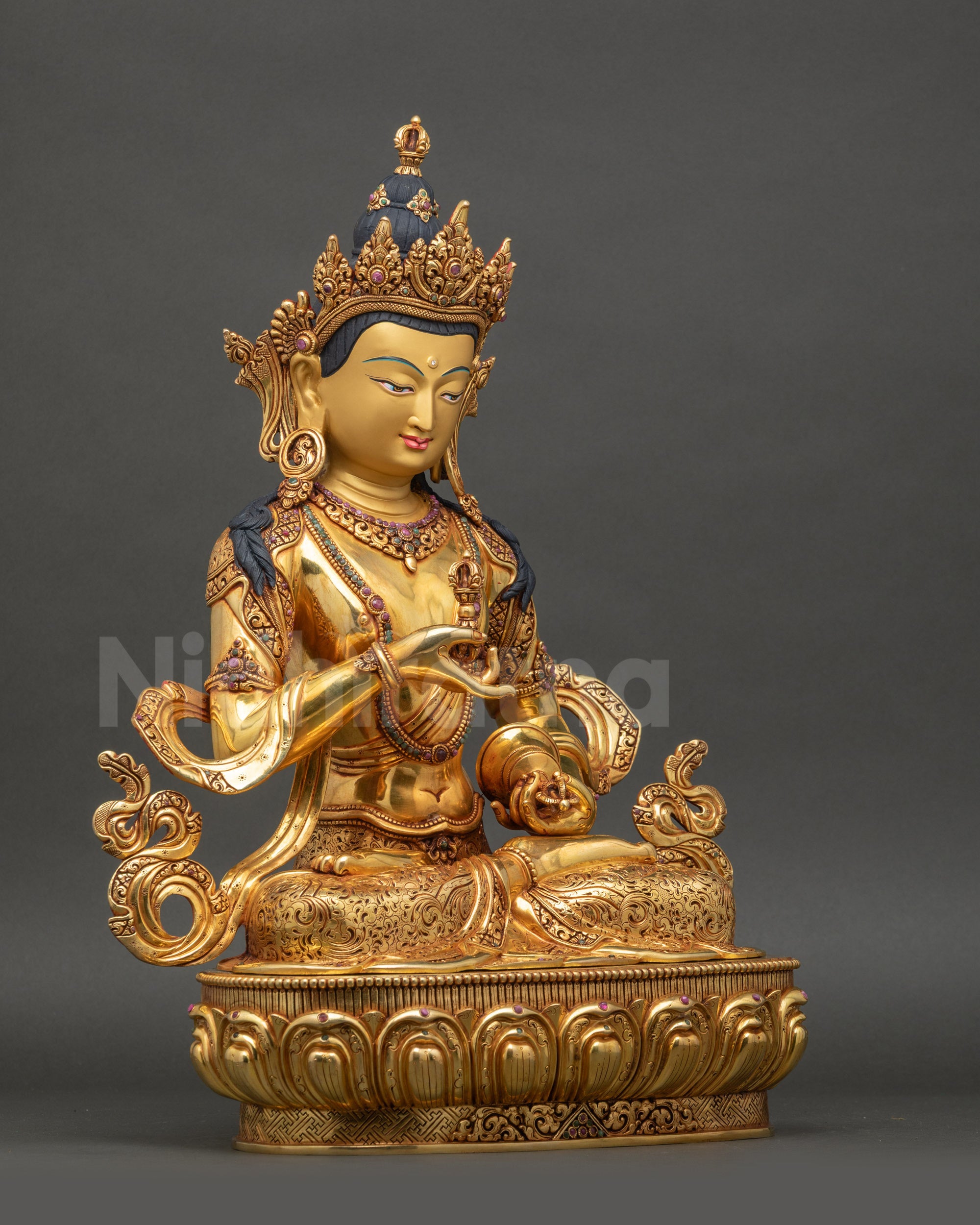 right view side of Vajrasattva Sculpture displaying flowing robe and carved lower garment
