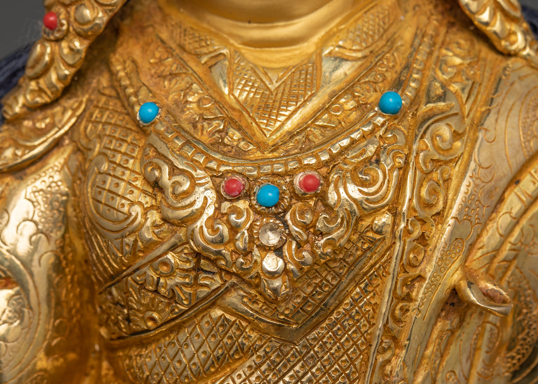 the chest of guru rinpoche statue showing his necklace