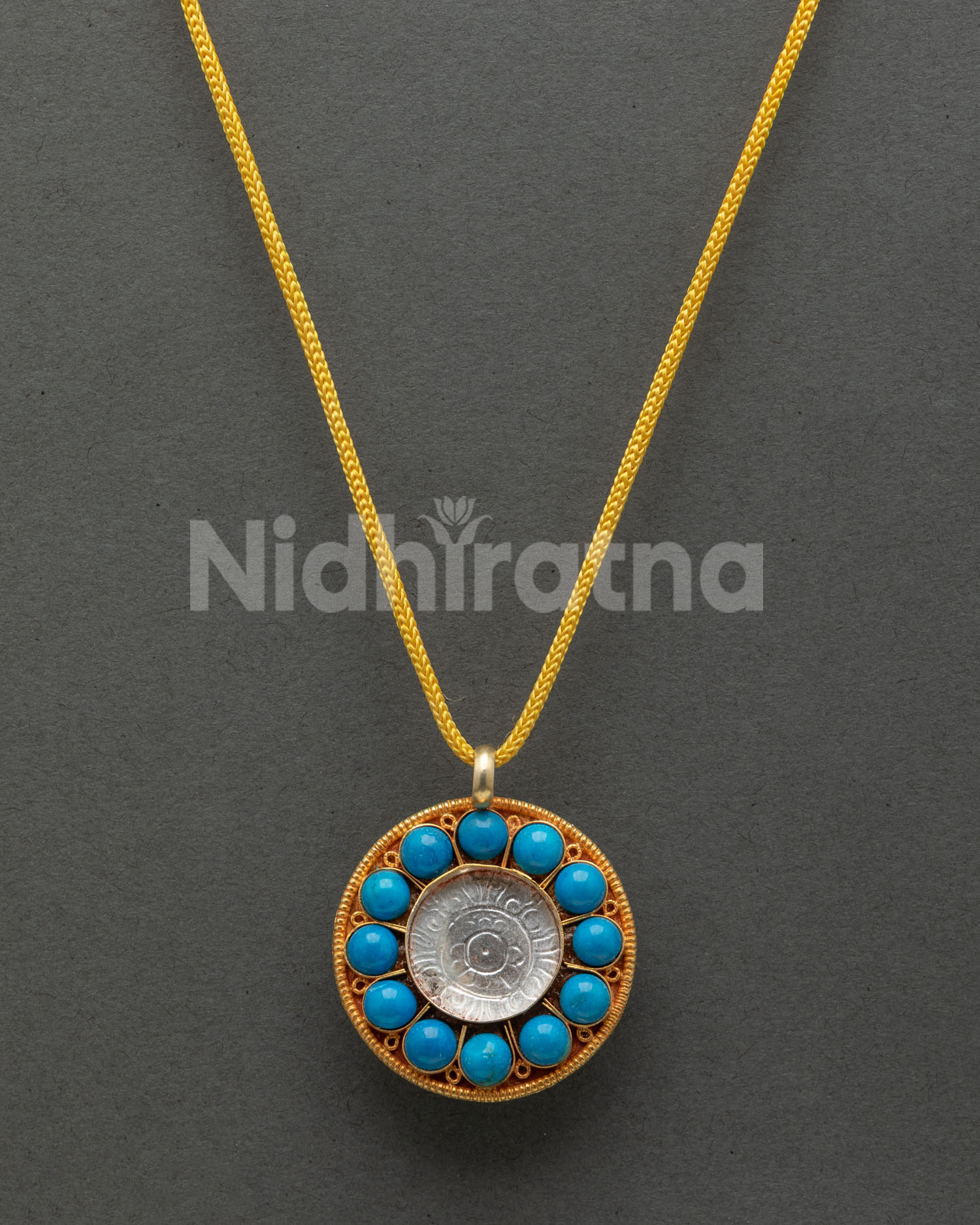 Round Buddhist locket with turquoise and coral gemstone details
