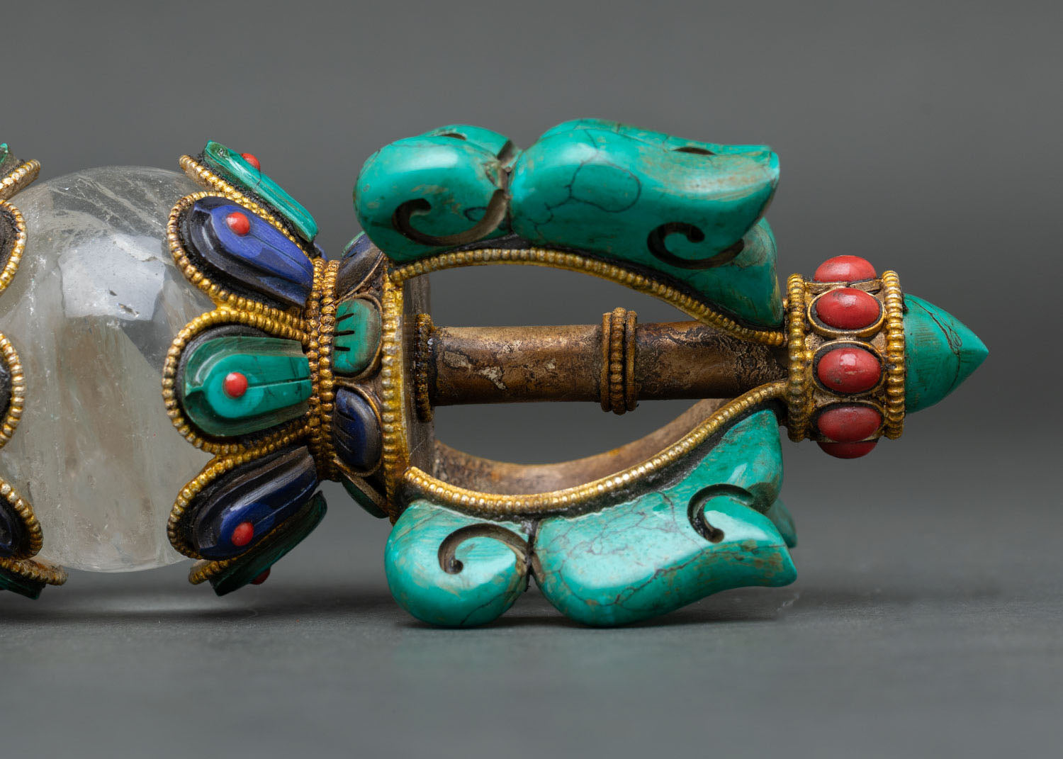 tibetan buddhist vajra with ornate copper body and semi-precious stone inlay