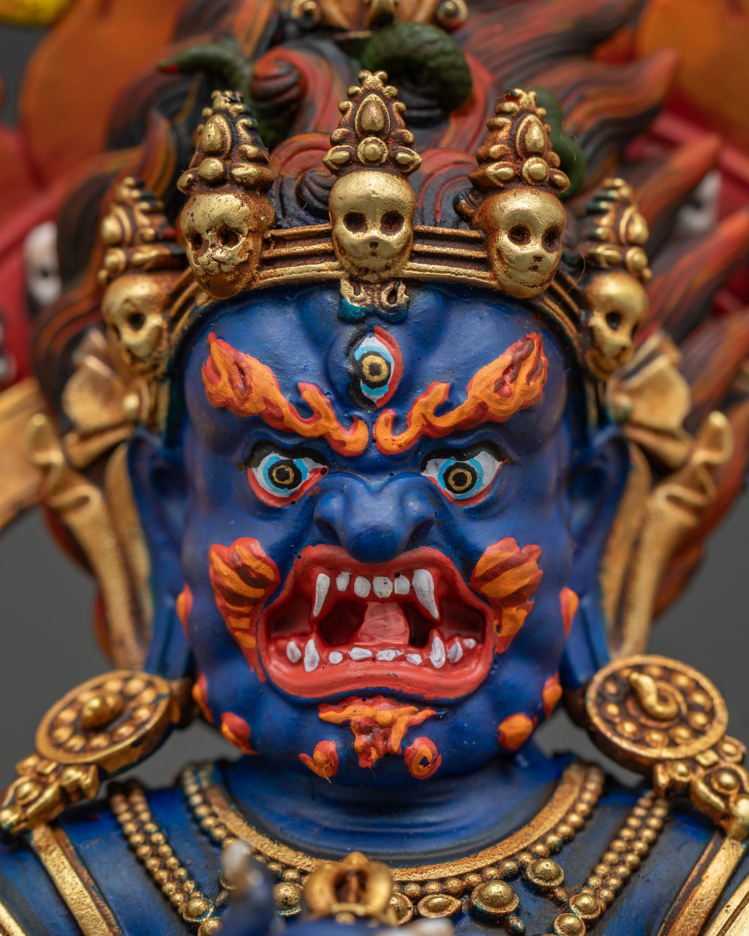 Sakya Mahakala statue detailed face close up with intricate gold gilded finish