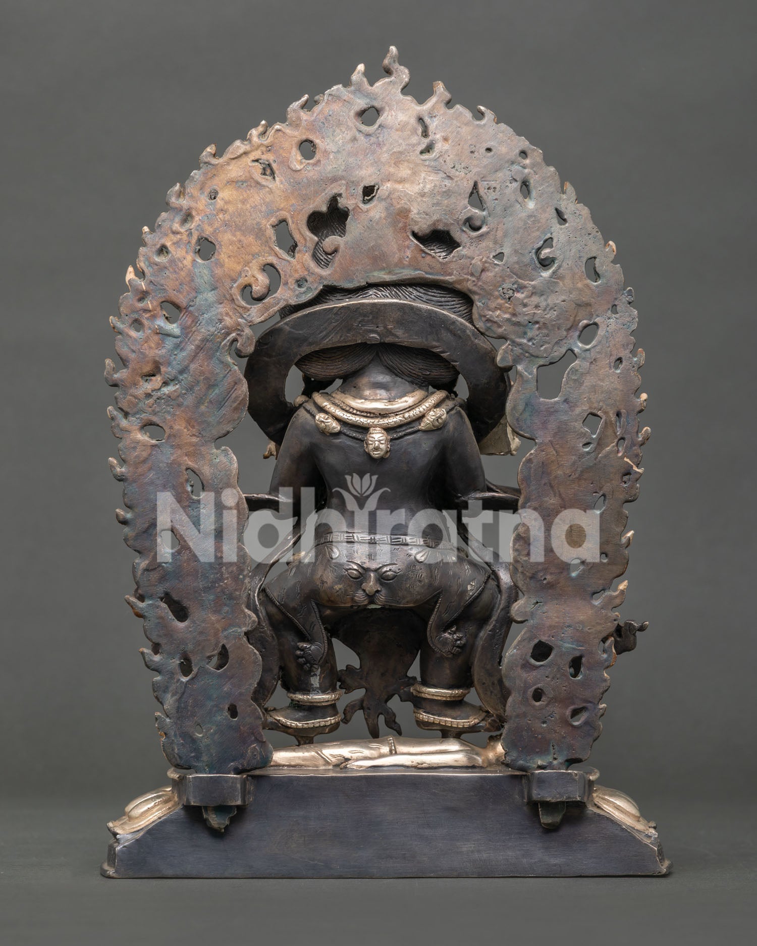 Sakya Mahakala statue subduing figure beneath feet, surrounded by blazing flames, symbolic Himalayan protector deity artwork from Nepal