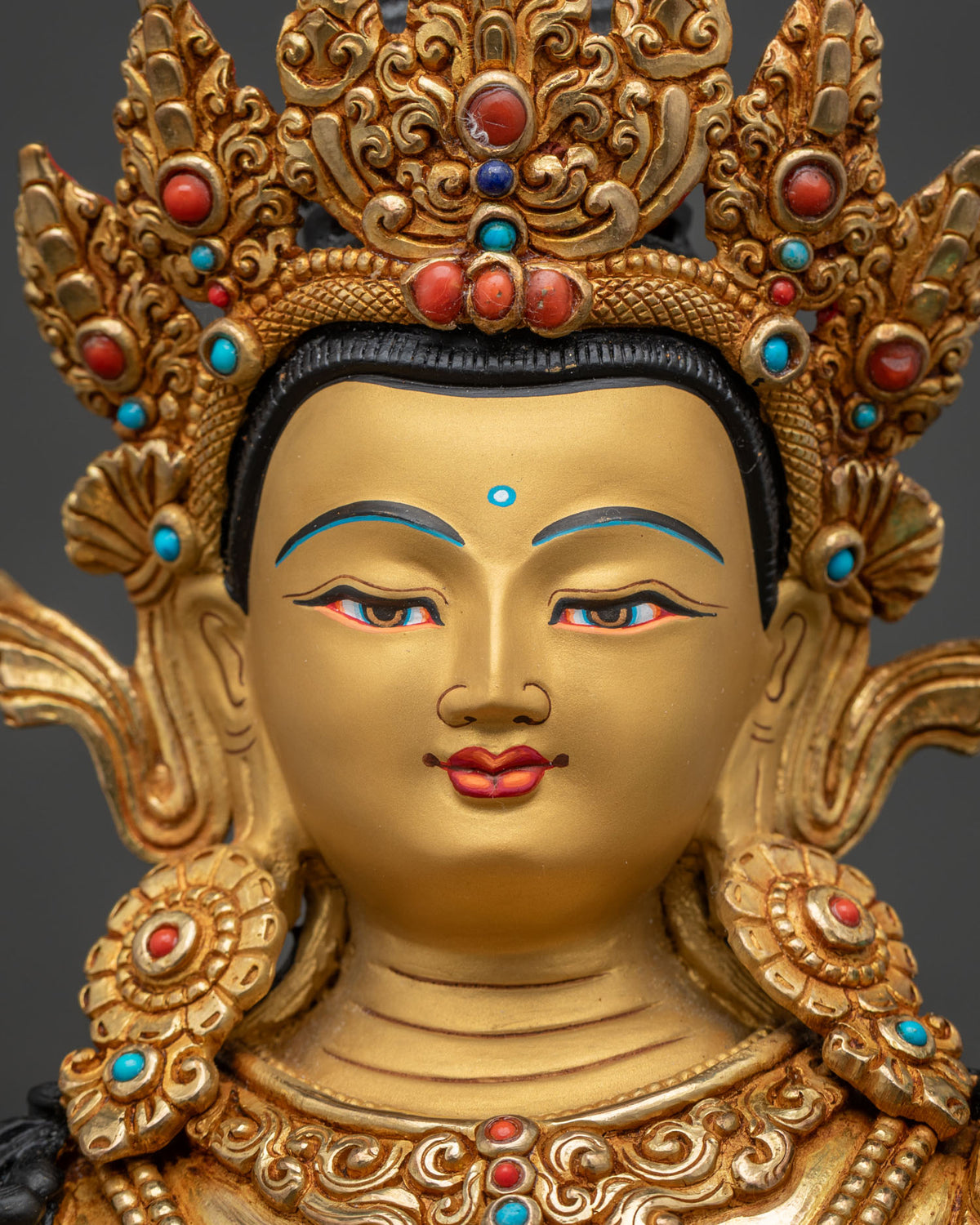 Samantabhadra statue detailed face close-up, gold-painted serene expression