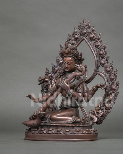 Saraswati Statue featuring a hand carved lotus pedestal and floral halo.
