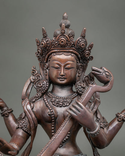 Saraswati Statue holding a rosary mala and sacred book.