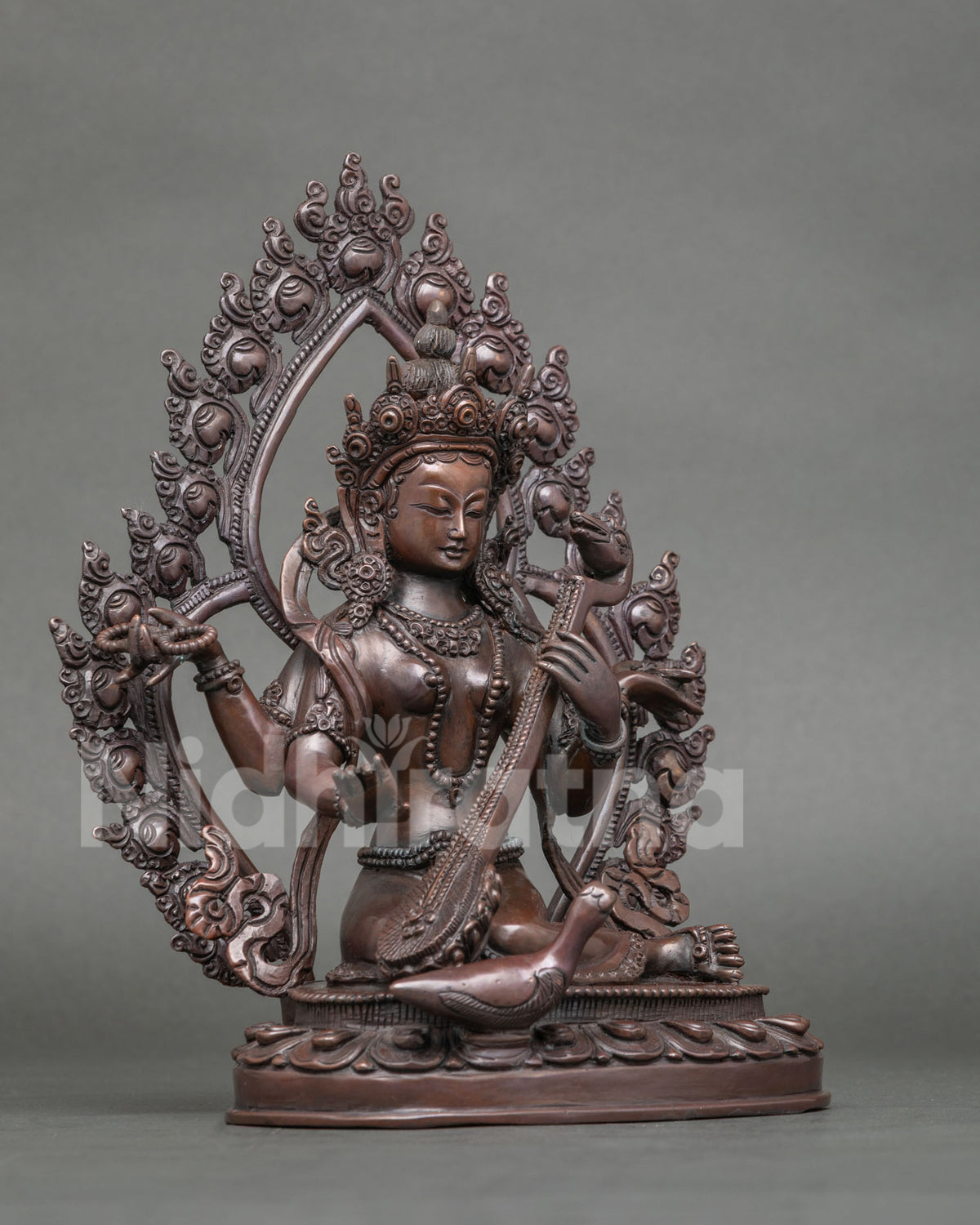 Saraswati Statue holding a veena symbolizing music knowledge and wisdom.