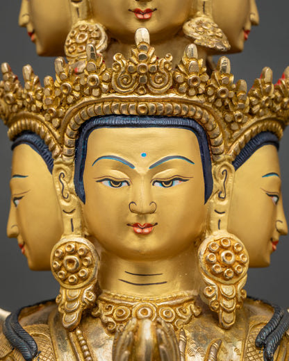 Serene face of Avalokiteshvara statue with ornate gold crown, earrings and hand-painted features