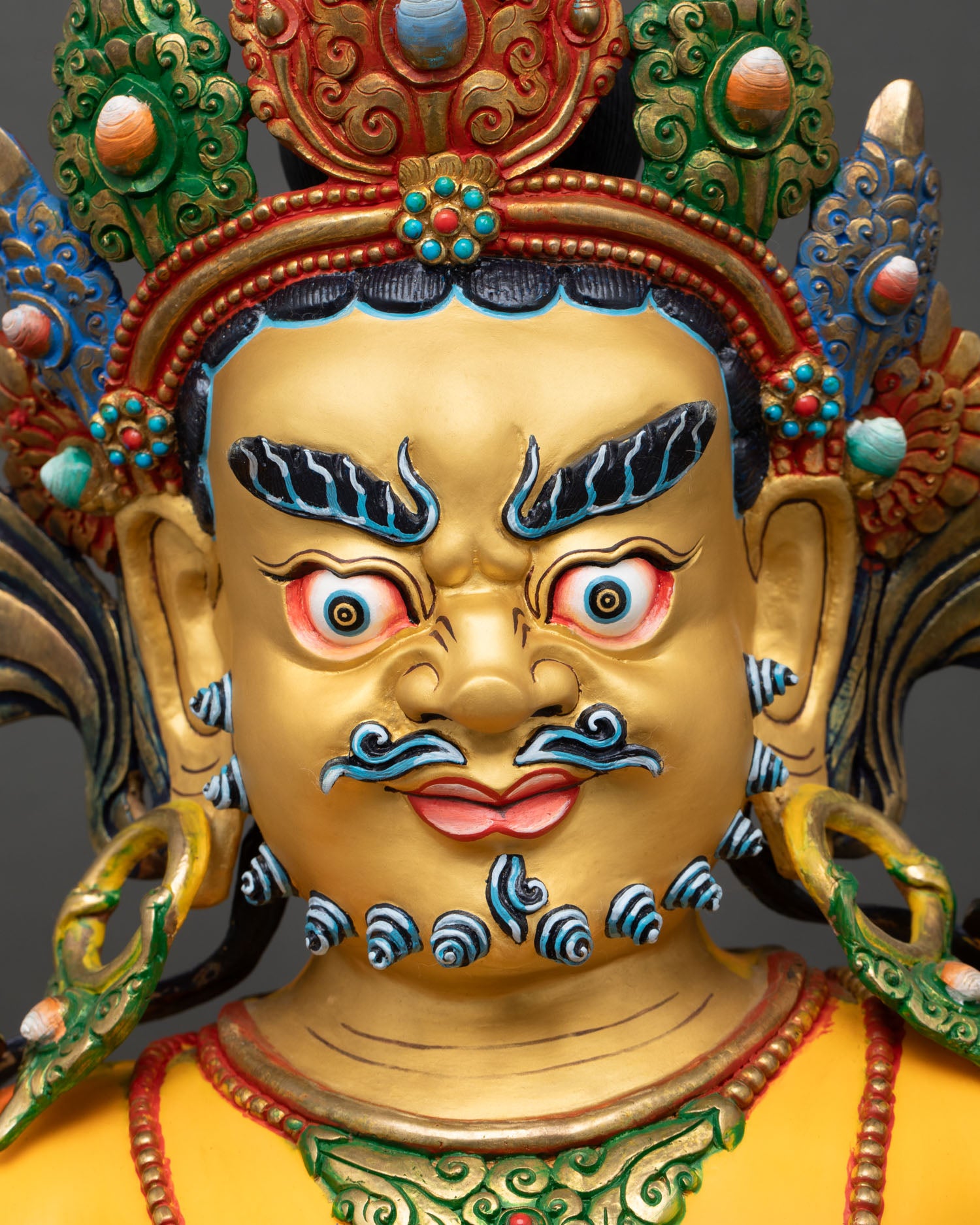 Serpo Dzambhala Buddha face, semi-wrathful gold-painted expression, shell crown and jeweled ornaments