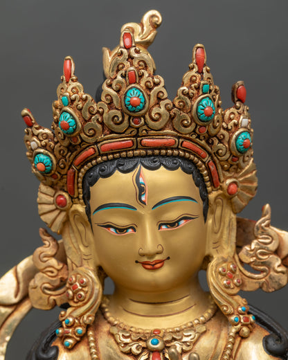 Face close-up of Seven-Eyed White Tara with serene gold-painted expression