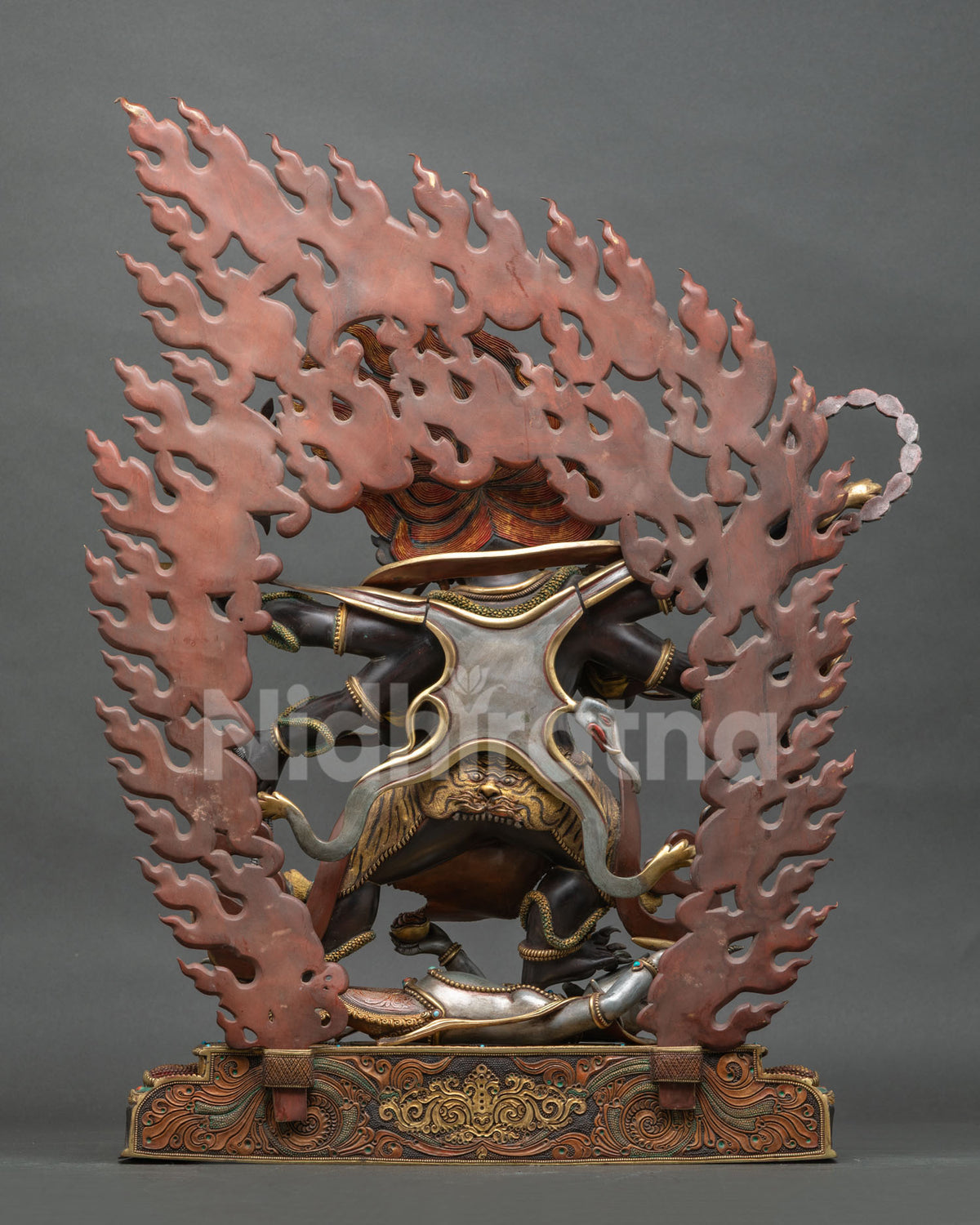 Shadbhuja Mahakala Statue back view with flaming hair and carved copper base detail