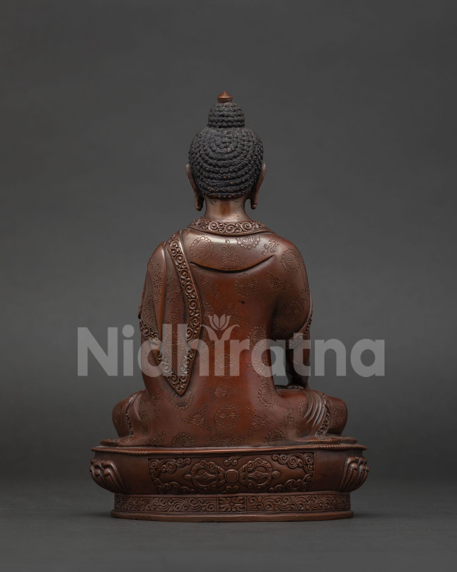 Shakyamuni Buddha back view displaying handcrafted lotus pedestal with vajra symbol.