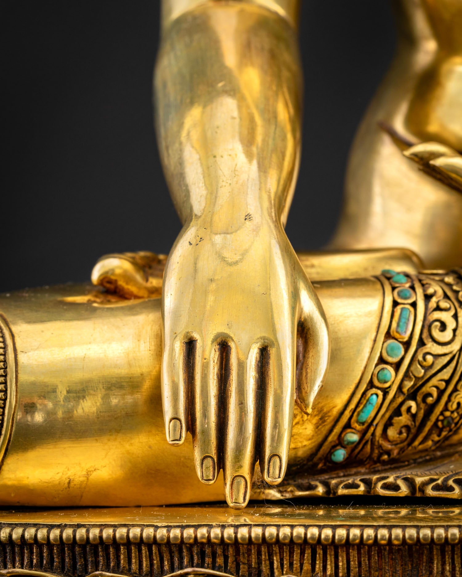 Shakyamuni Buddha Bhumisparsha mudra close-up – earth-touching gesture in 24K gilded copper