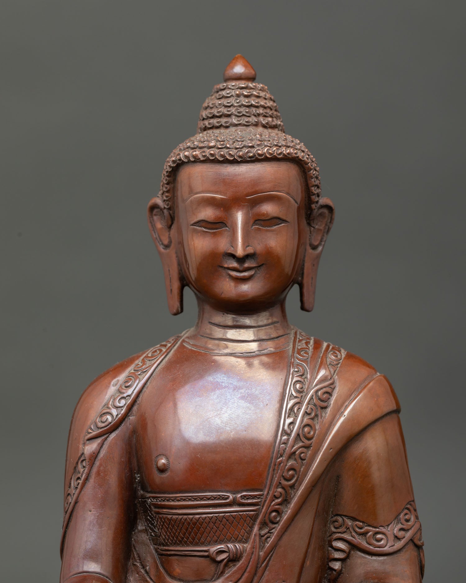 Shakyamuni Buddha face detail showing peaceful expression, Himalayan Buddhist craftsmanship, and enlightened presence.