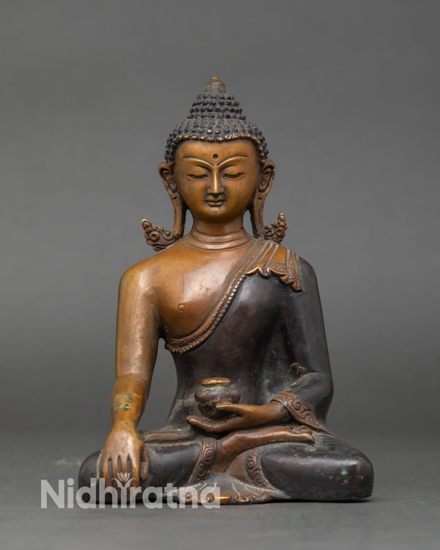 Shakyamuni Buddha statue earth touching Bhumisparsha mudra oxidized copper lotus pedestal Himalayan Buddhist sculpture representing enlightenment and awakening