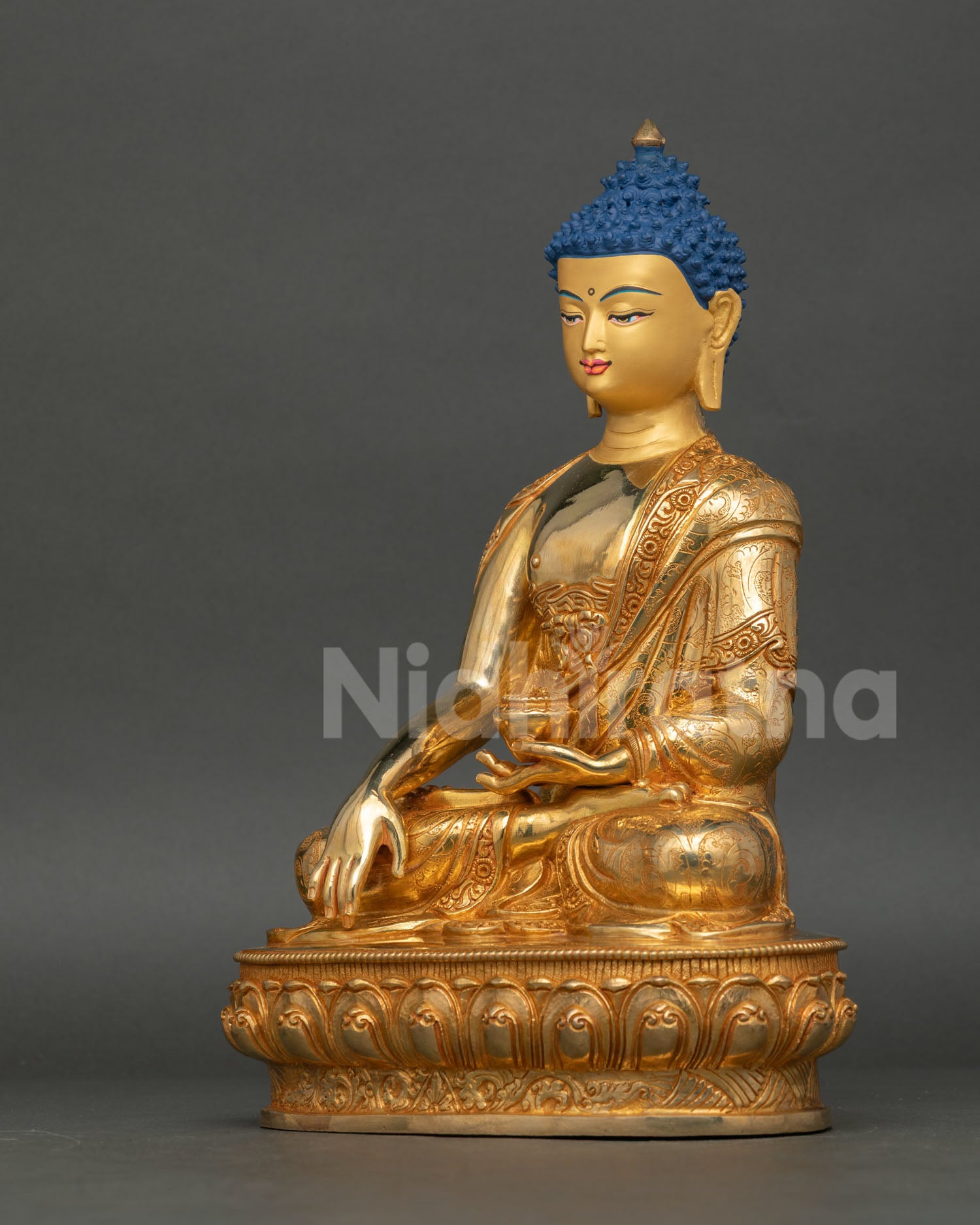 Shakyamuni Buddha holding begging bowl seated on lotus throne traditional Buddhist sculpture Nepal