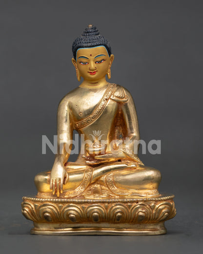 Shakyamuni Buddha meditating statue holding begging bowl with earth touching mudra on lotus throne.
