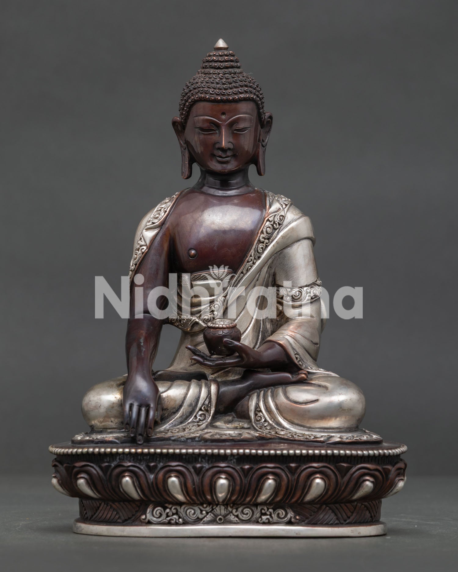 Shakyamuni Buddha oxidized silver plated copper statue seated on lotus throne front view.