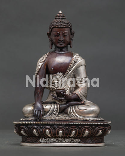 Shakyamuni Buddha oxidized silver plated copper statue seated on lotus throne front view.