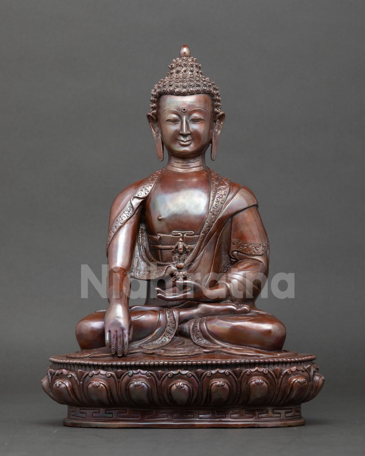 Shakyamuni Buddha sculpture in oxidized copper representing the Buddha of enlightenment seated on a lotus throne holding a begging bowl.