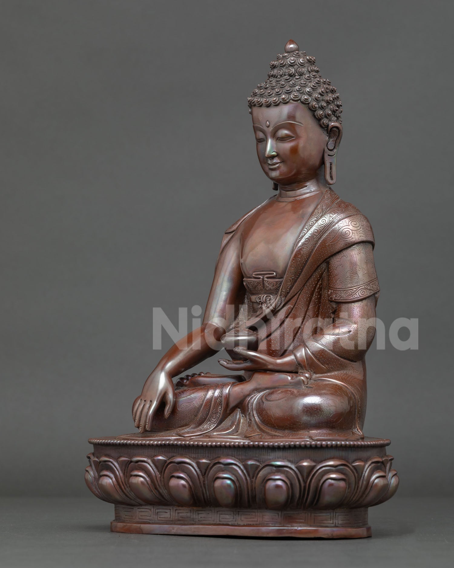 Shakyamuni Buddha seated on lotus throne in earth touching mudra holding begging bowl symbolizing enlightenment.
