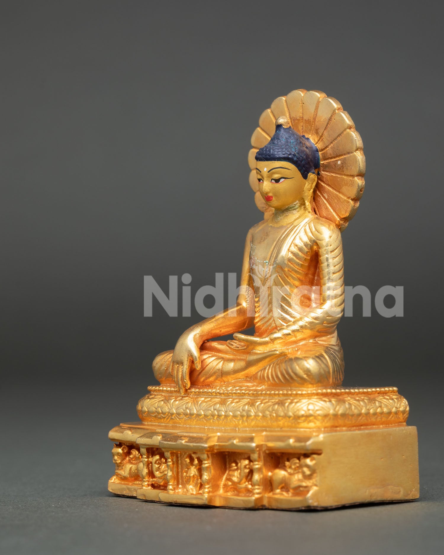 Shakyamuni Buddha seated on ornate throne with lotus base and traditional Buddhist craftsmanship.