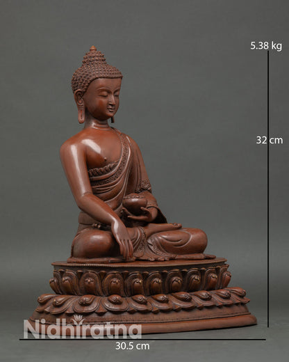 Shakyamuni Buddha side view flowing monastic robes detailed craftsmanship lost wax copper Buddhist sculpture from Patan Nepal.