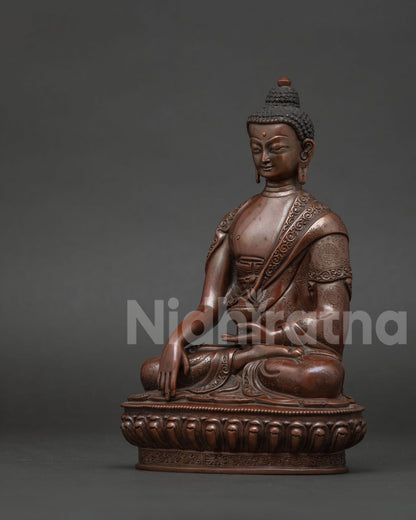 Shakyamuni Buddha side view showing lotus pedestal oxidized copper finish.