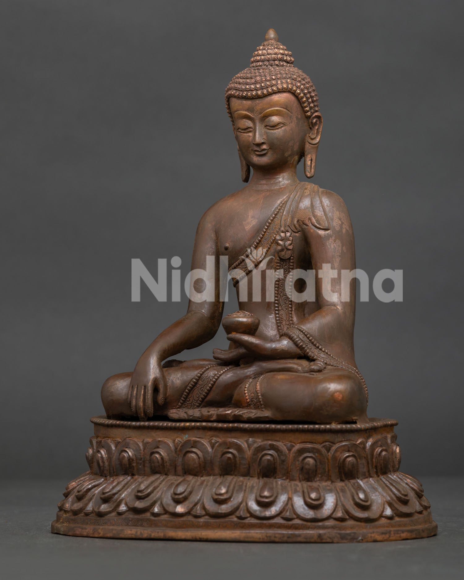 Shakyamuni Buddha side view showing Bhumisparsha Mudra and monk’s begging bowl.